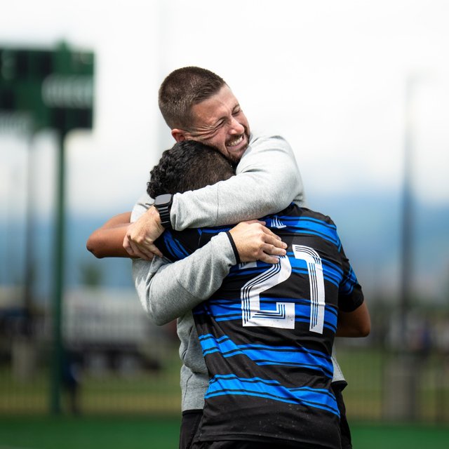 Connor MacDonald embracing a player after a match