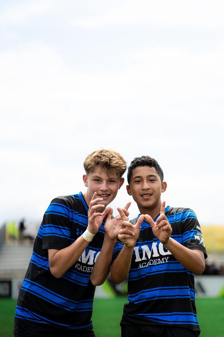 Two Development Academy players celebrating a win