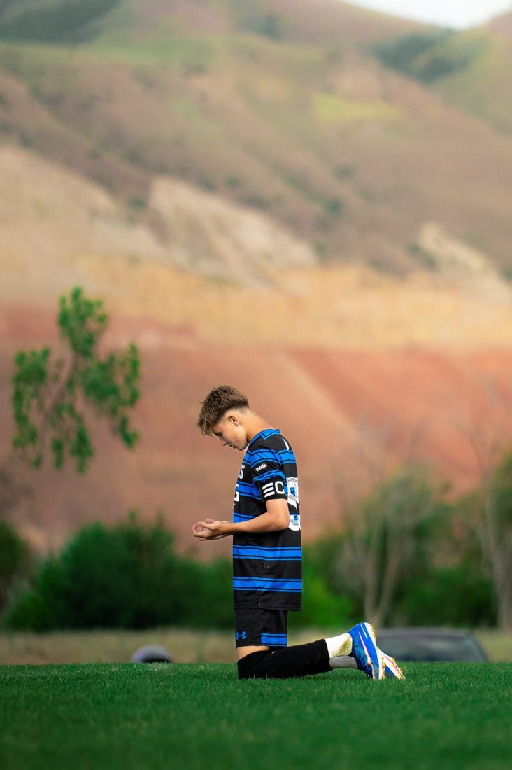 A player taking a quiet moment on the pitch